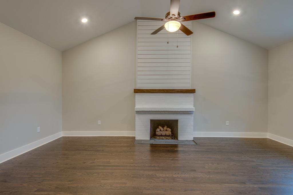 1200 Davidson Road Nashville, TN 37205 - Photo 14 of 30 a view of an empty room with wooden floor fireplace and a window