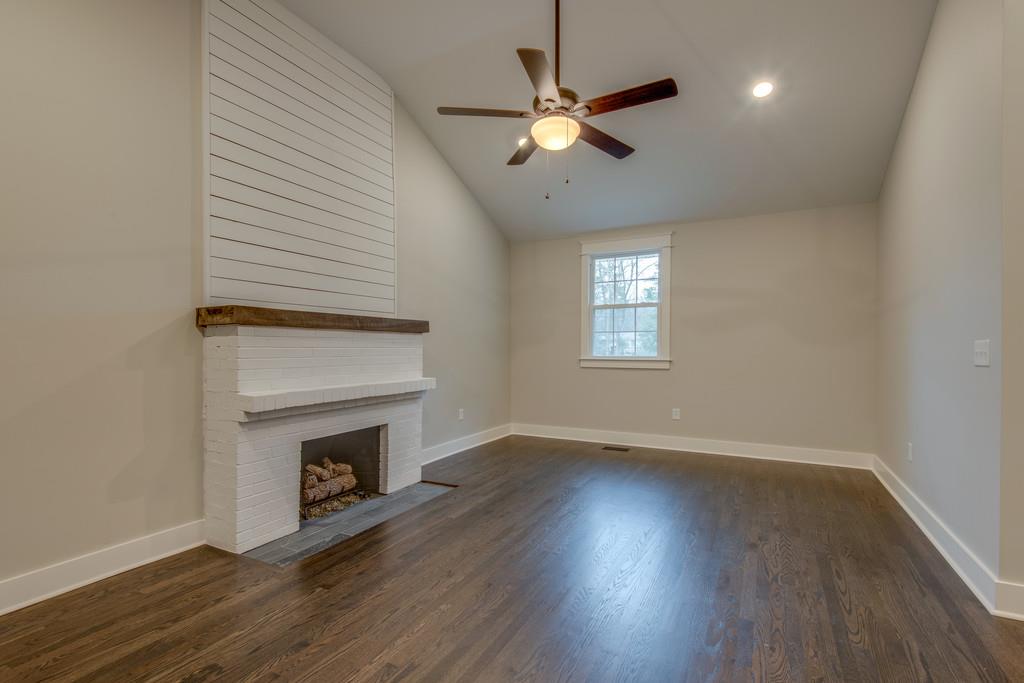 1200 Davidson Road Nashville, TN 37205 - Photo 15 of 30 an empty room with wooden floor fireplace and windows