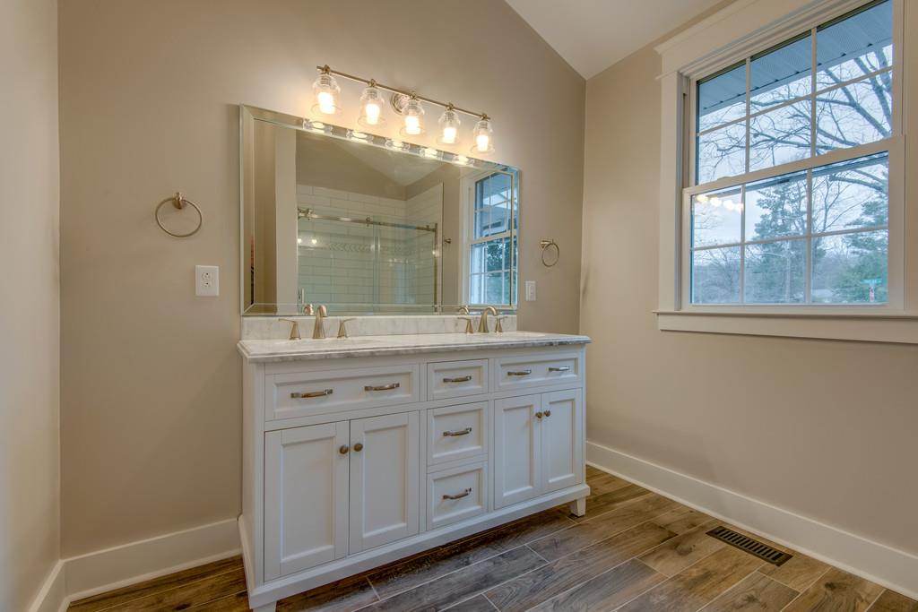 1200 Davidson Road Nashville, TN 37205 - Photo 16 of 30 a bathroom with a double vanity sink and a mirror
