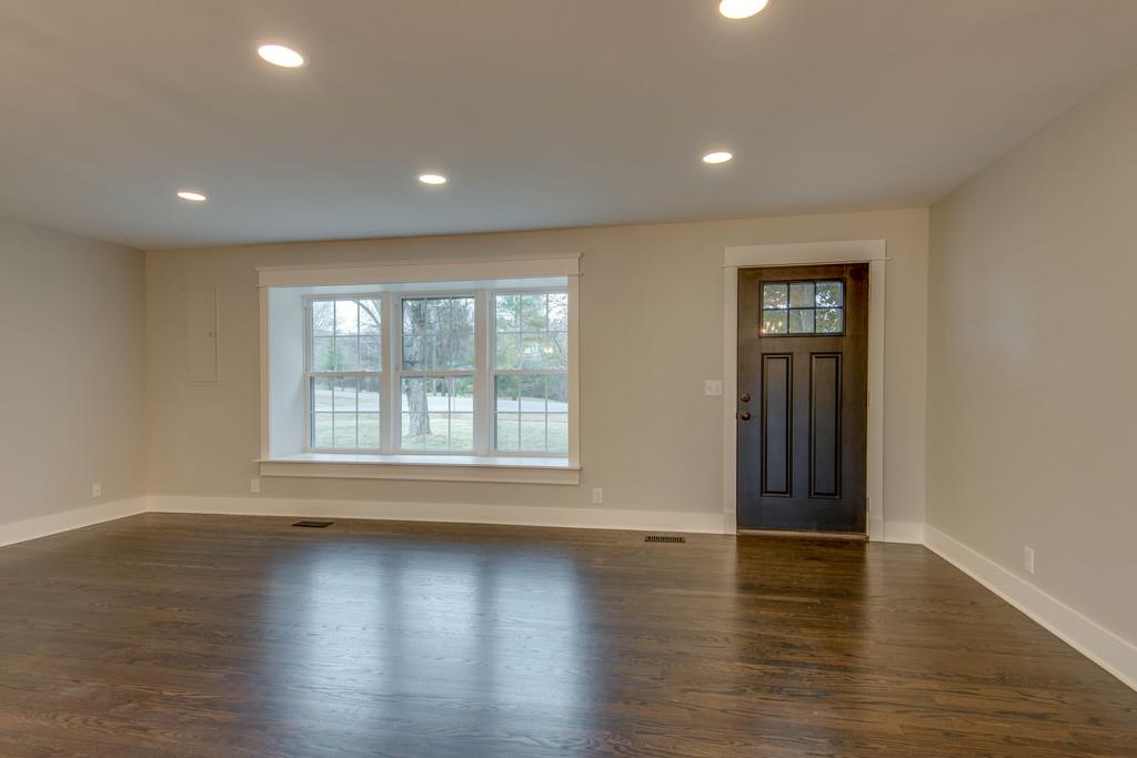 1200 Davidson Road Nashville, TN 37205 - Photo 4 of 30 an empty room with wooden floor and windows with curtains