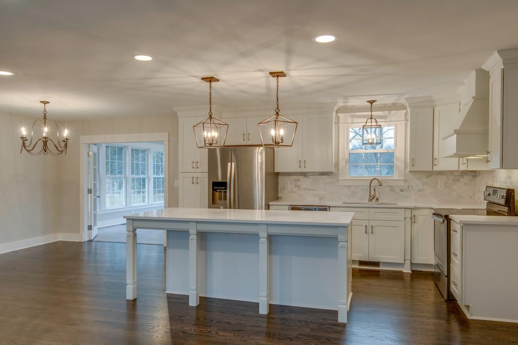 1200 Davidson Road Nashville, TN 37205 - Photo 6 of 30 a large kitchen with granite countertop a stove a sink a window and wooden floor