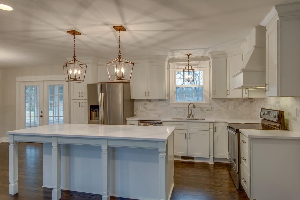 1200 Davidson Road Nashville, TN 37205 - Photo 8 of 30 a kitchen with stainless steel appliances granite countertop a sink a stove a refrigerator and island with wooden floor