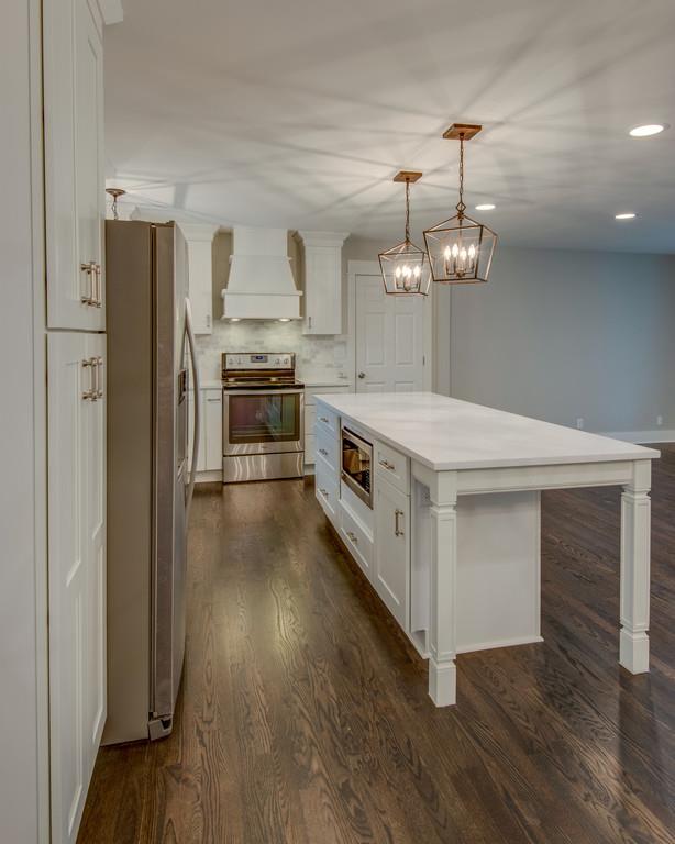 1200 Davidson Road Nashville, TN 37205 - Photo 10 of 30 a large kitchen with stainless steel appliances a large counter top a sink a stove and a refrigerator