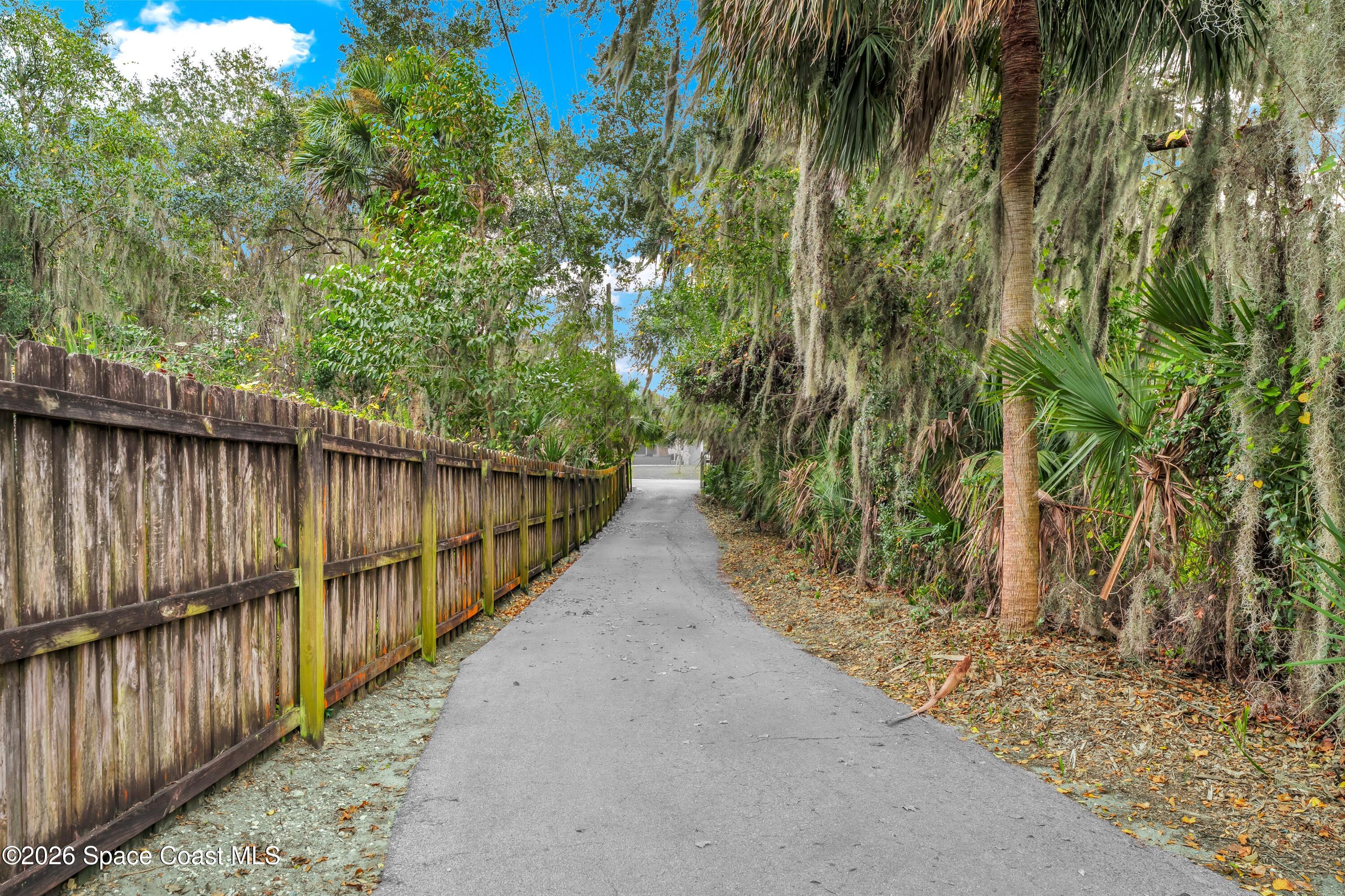 4150 Heller Road Titusville, FL 32796 - Photo 11 of 65 a view of a pathway of a park with large trees