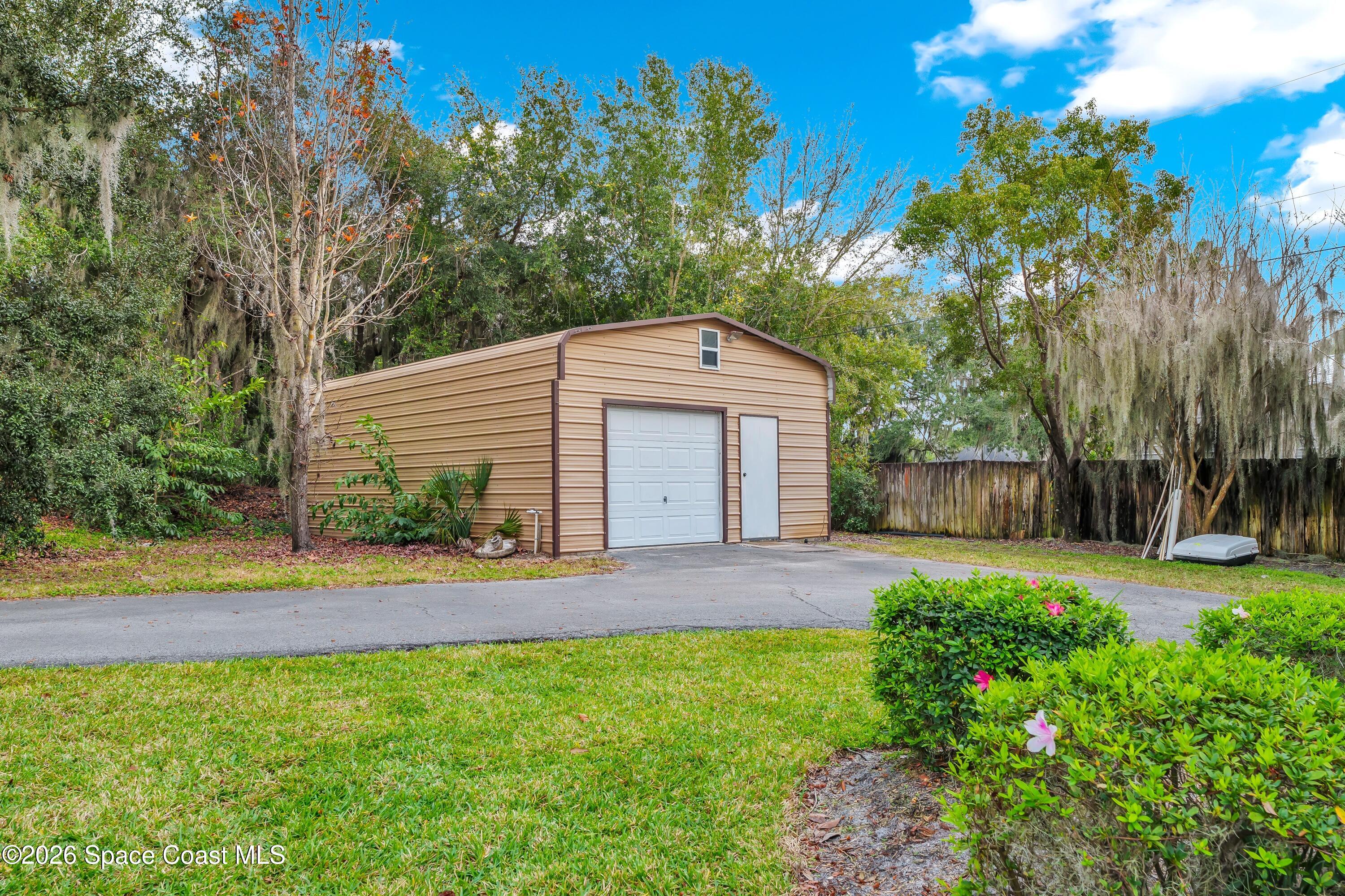 4150 Heller Road Titusville, FL 32796 - Photo 14 of 65 a front view of a house with a yard and pathway