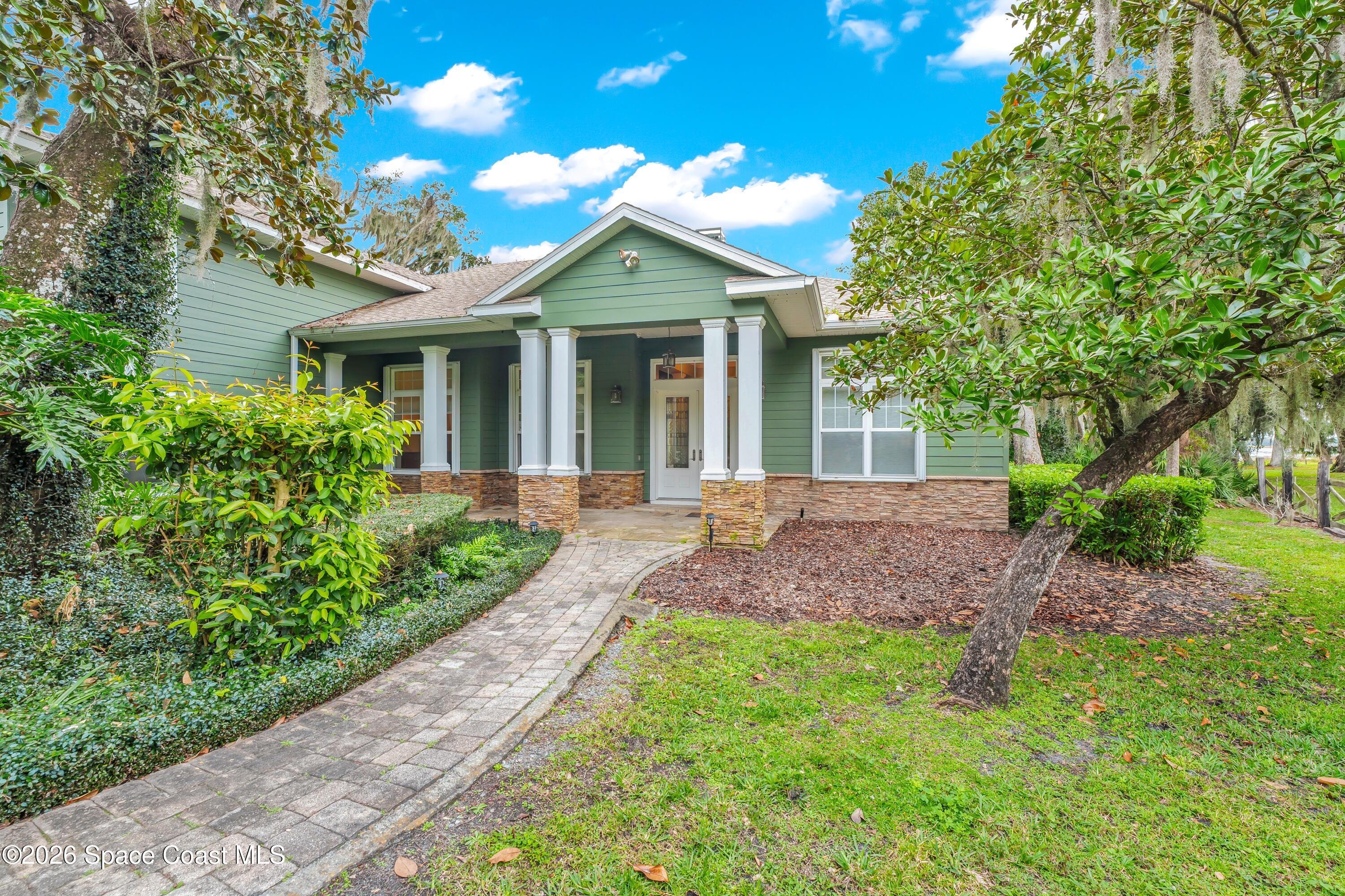 4150 Heller Road Titusville, FL 32796 - Photo 2 of 65 a front view of a house with a yard