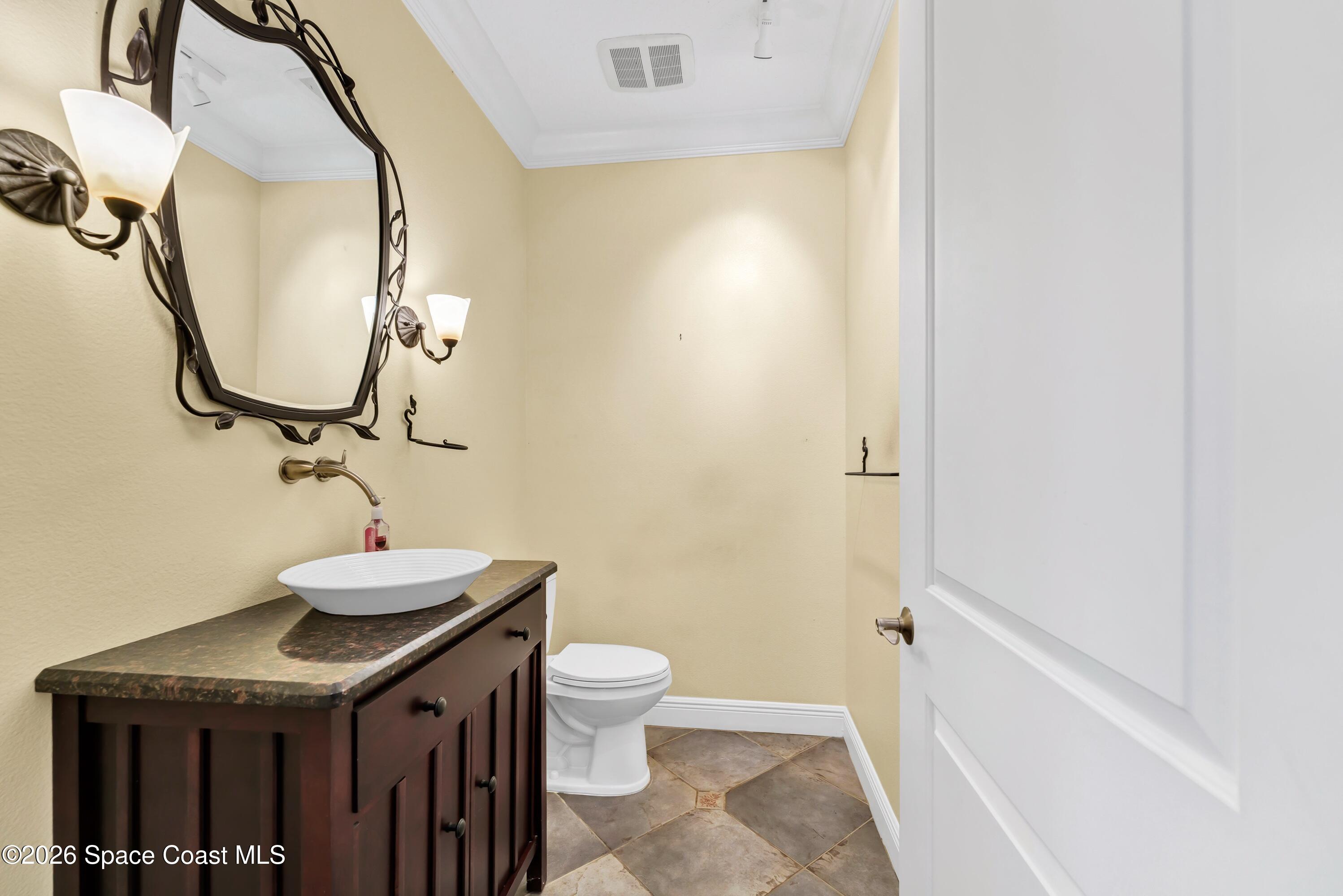 4150 Heller Road Titusville, FL 32796 - Photo 25 of 65 a bathroom with a granite countertop sink and a mirror