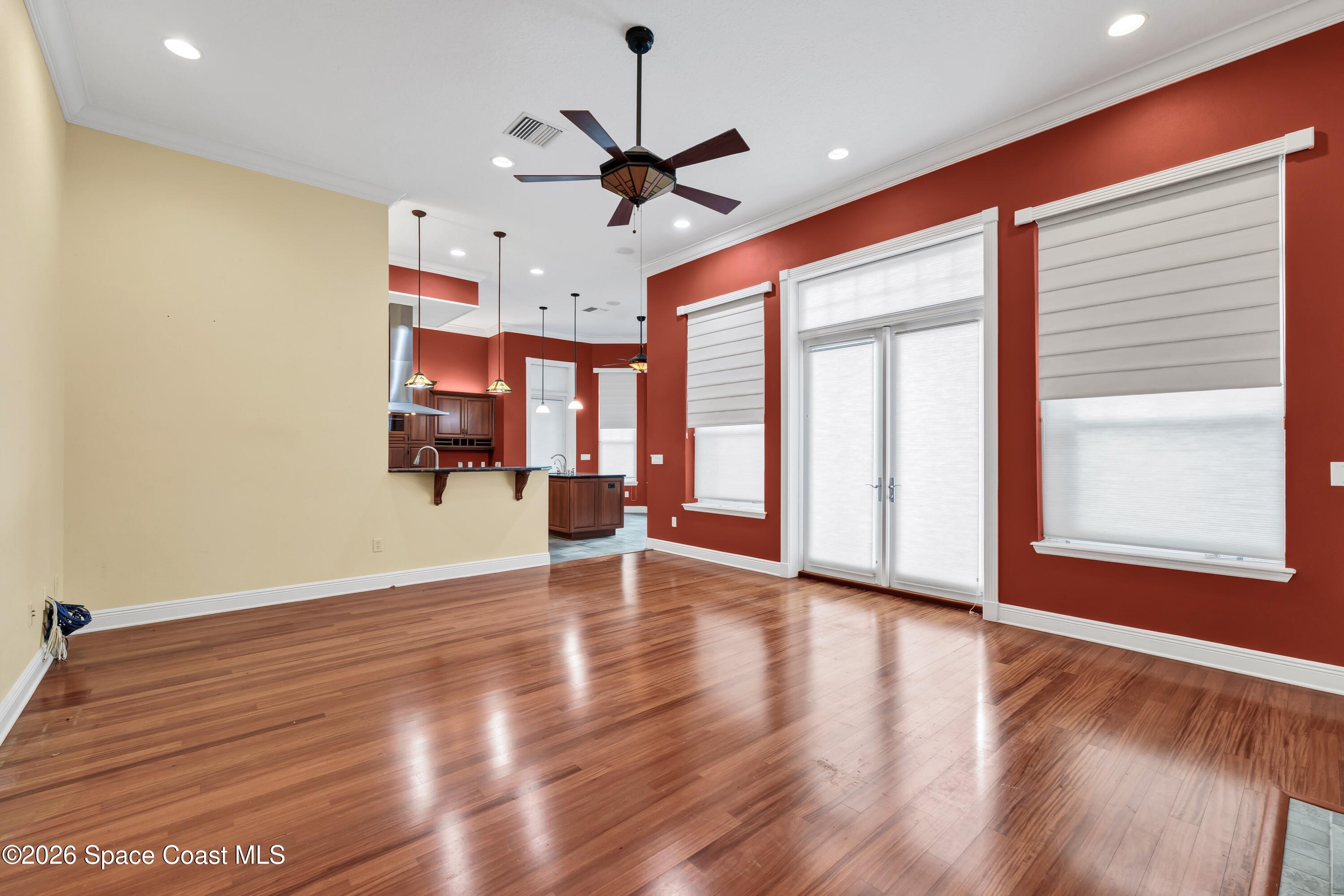 4150 Heller Road Titusville, FL 32796 - Photo 26 of 65 a view of an empty room with a window and wooden floor