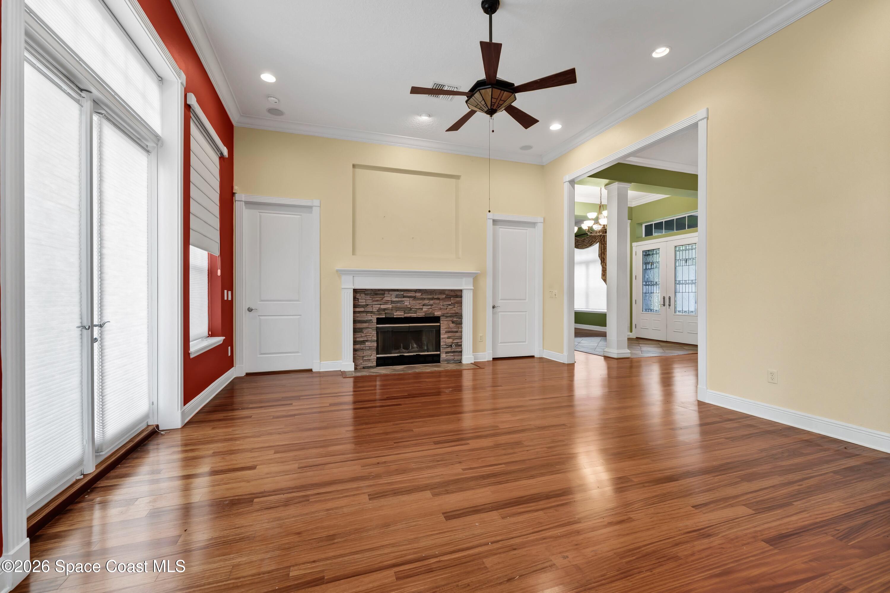 4150 Heller Road Titusville, FL 32796 - Photo 29 of 65 a view of an empty room with wooden floor fireplace and a window
