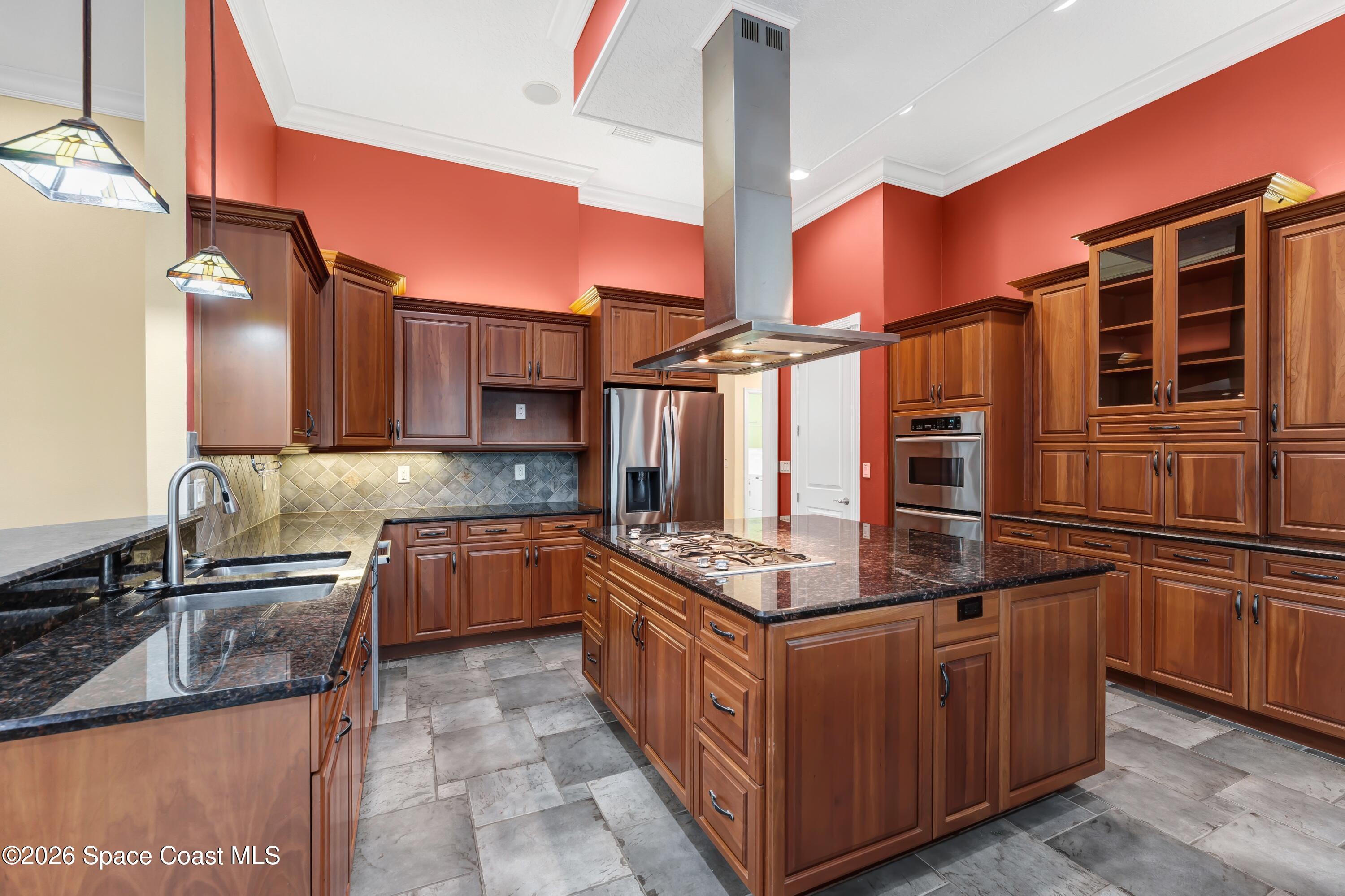 4150 Heller Road Titusville, FL 32796 - Photo 31 of 65 a kitchen with stainless steel appliances granite countertop a stove a sink and a refrigerator