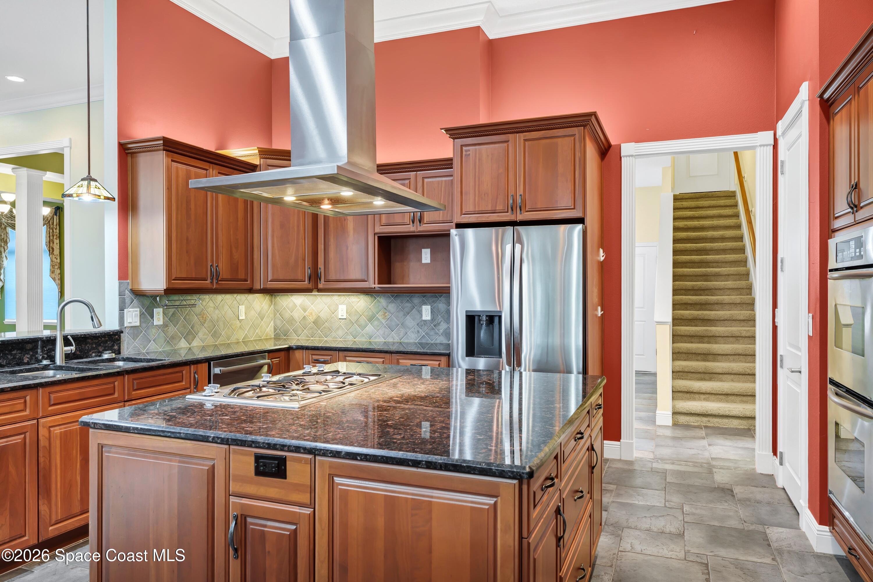 4150 Heller Road Titusville, FL 32796 - Photo 33 of 65 a kitchen with stainless steel appliances granite countertop a sink and a refrigerator