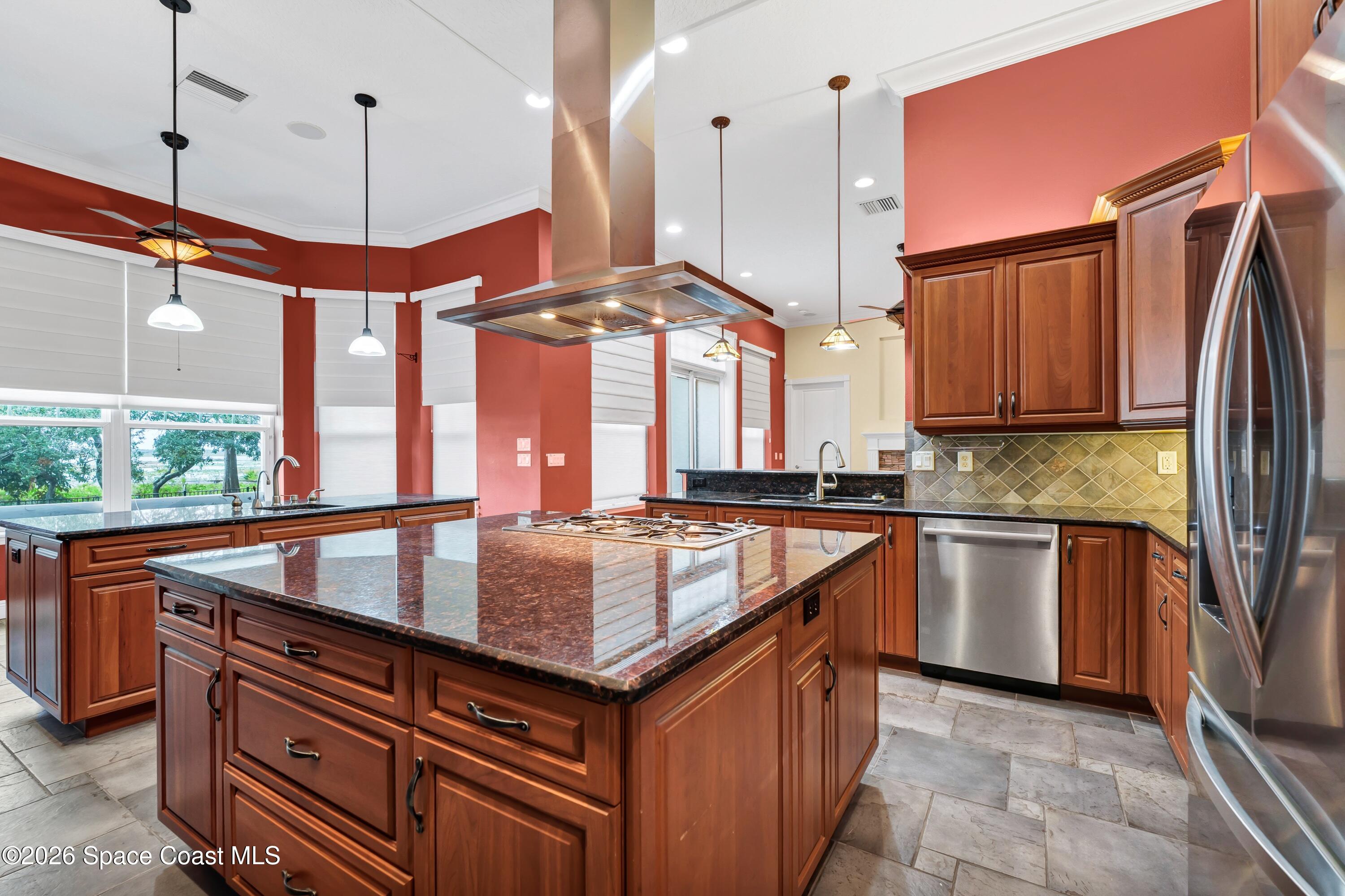 4150 Heller Road Titusville, FL 32796 - Photo 35 of 65 a kitchen with stainless steel appliances granite countertop a sink a stove and a wooden floors