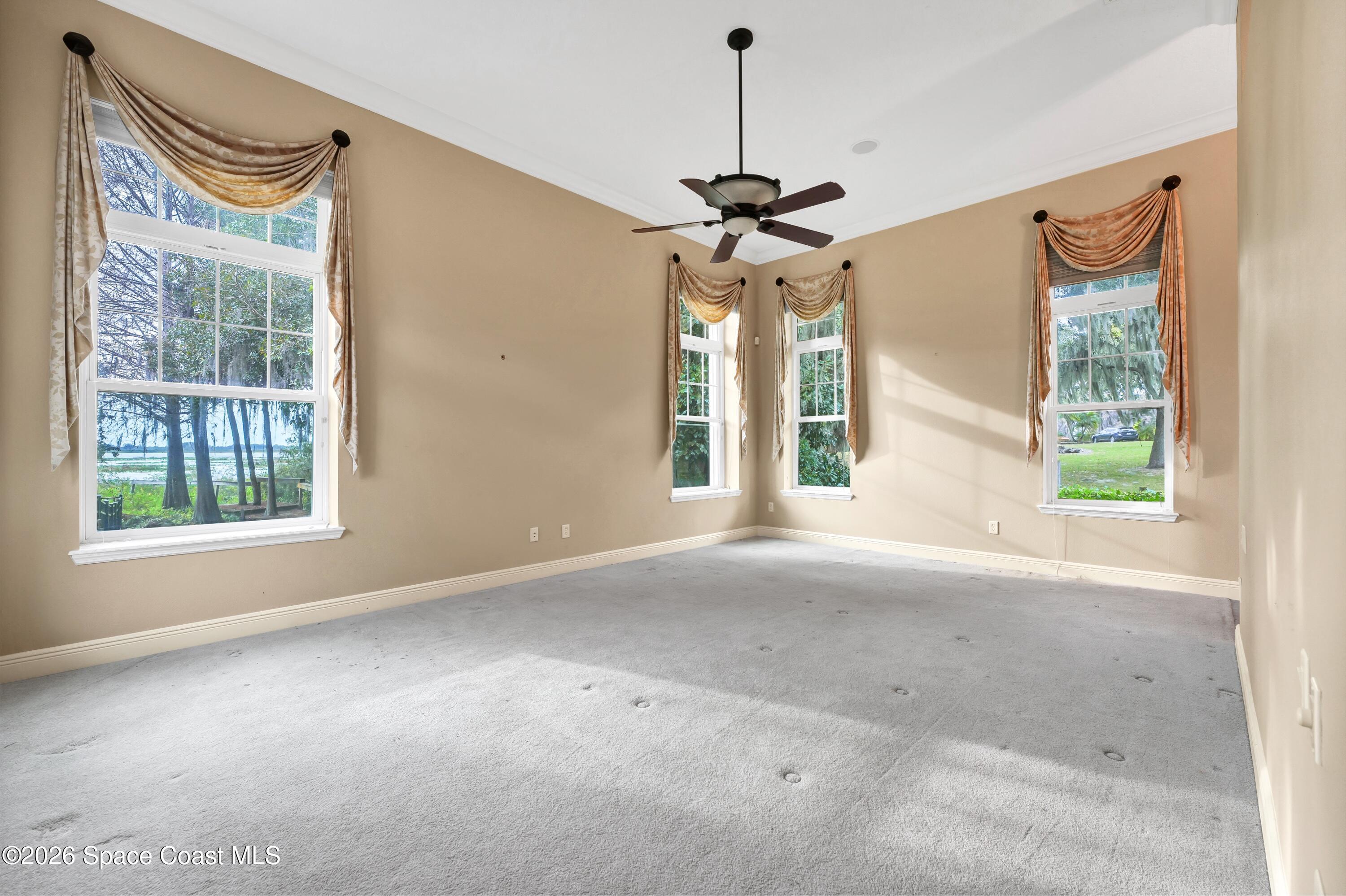 4150 Heller Road Titusville, FL 32796 - Photo 39 of 65 a view of a livingroom with a ceiling fan and window