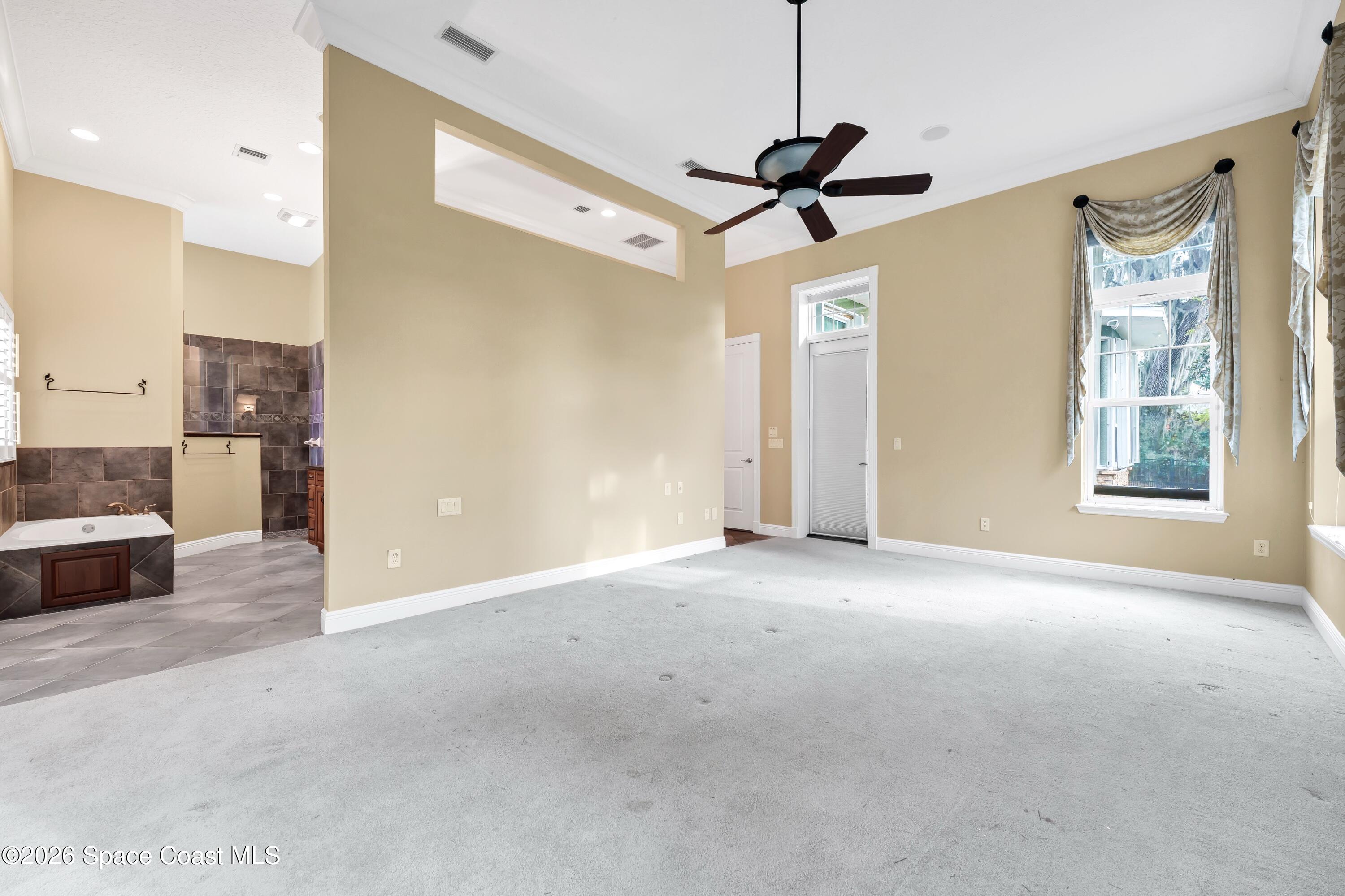 4150 Heller Road Titusville, FL 32796 - Photo 40 of 65 a view of a livingroom with a ceiling fan and window