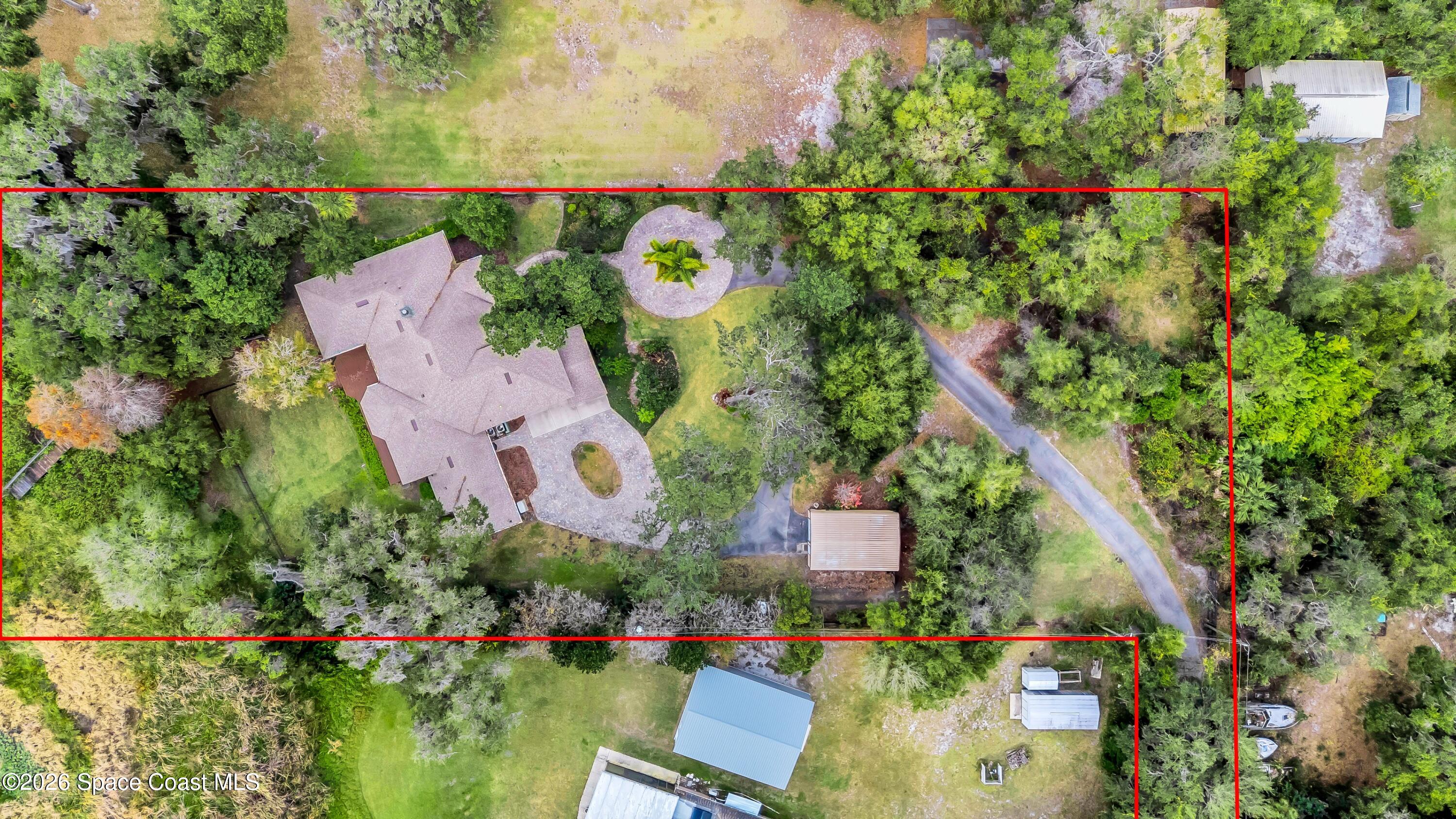 4150 Heller Road Titusville, FL 32796 - Photo 55 of 65 an aerial view of a house with a garden and lake view