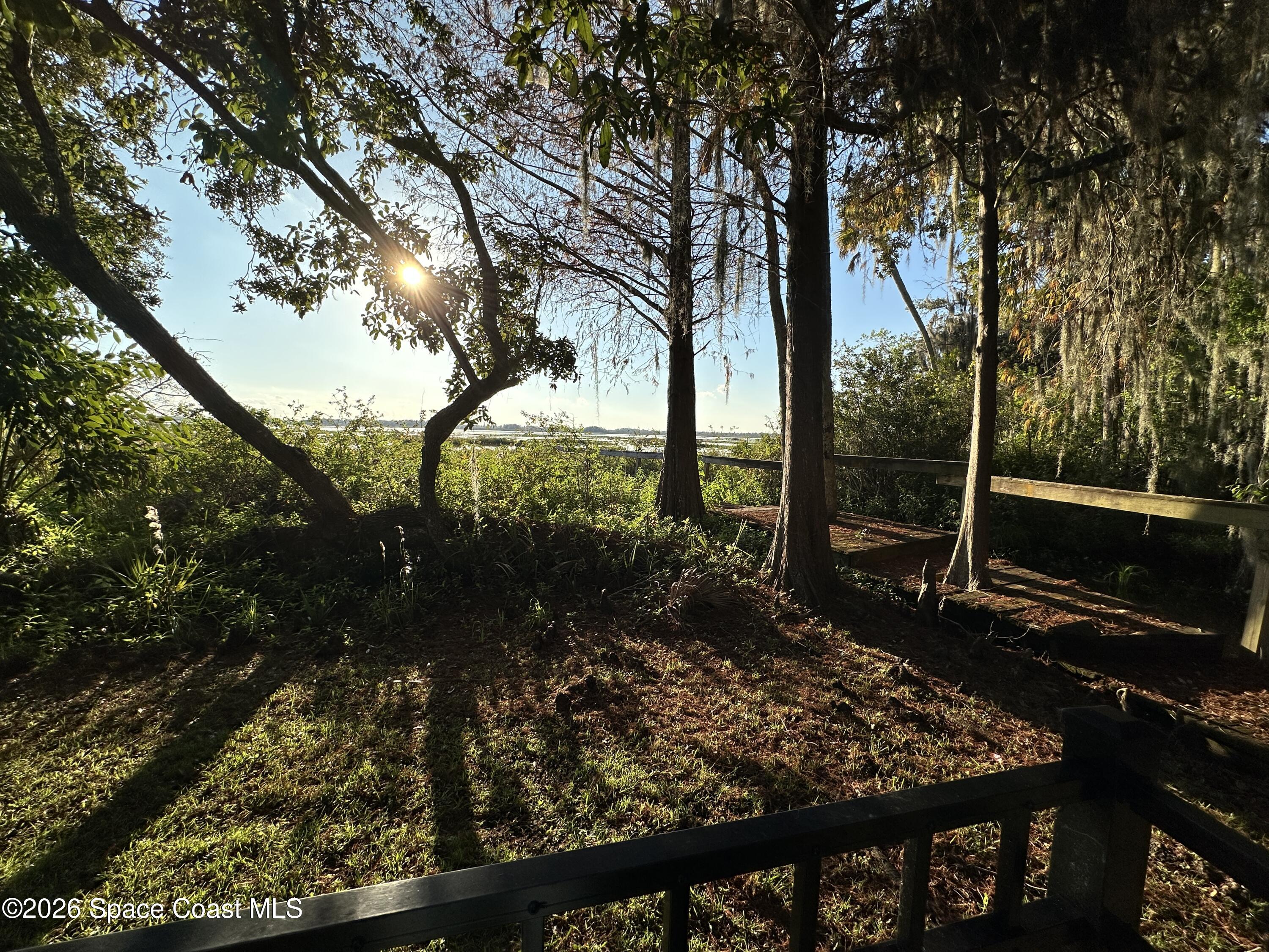 4150 Heller Road Titusville, FL 32796 - Photo 8 of 65 a view of a backyard with floor to ceiling window and wooden fence