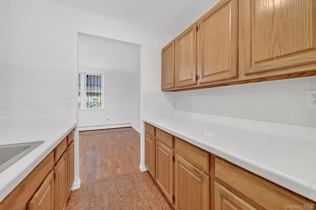 a kitchen with granite countertop white cabinets and sink
