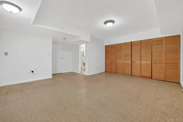 a view of an empty room with closet
