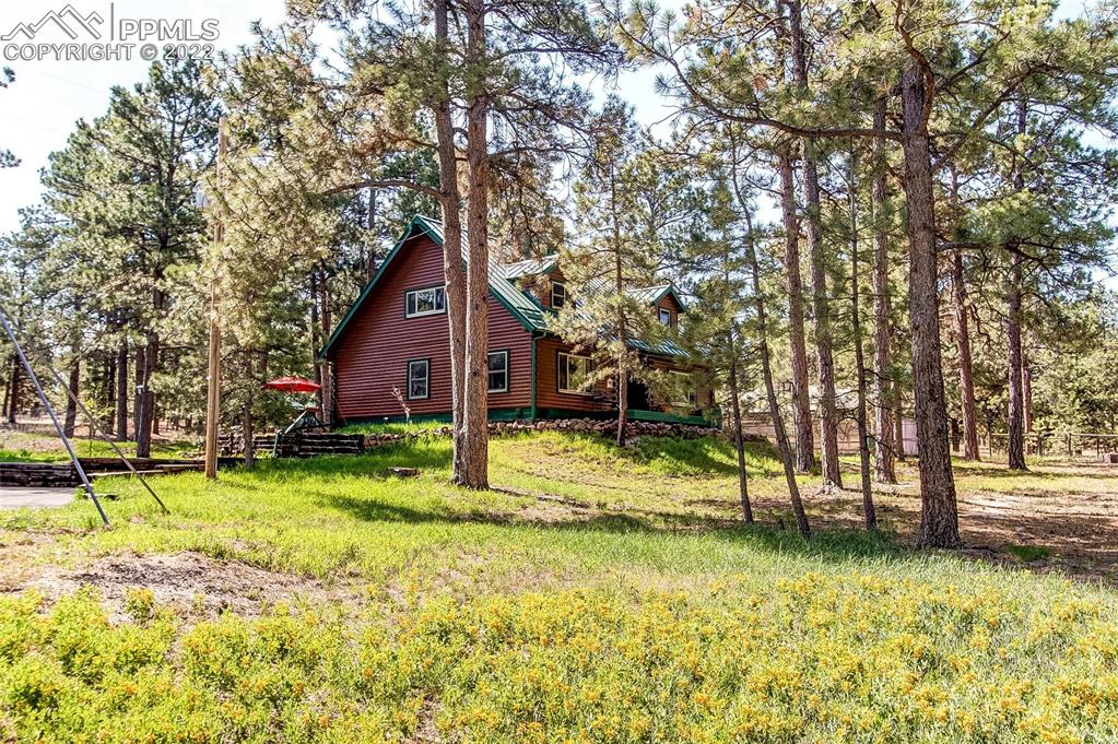 5030 Cedar Way Elizabeth, CO 80107 - Photo 2 of 33 a backyard of a house with swimming pool