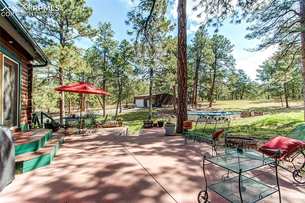 5030 Cedar Way Elizabeth, CO 80107 - Photo 25 of 33 an outdoor space with patio lots of furniture and umbrella
