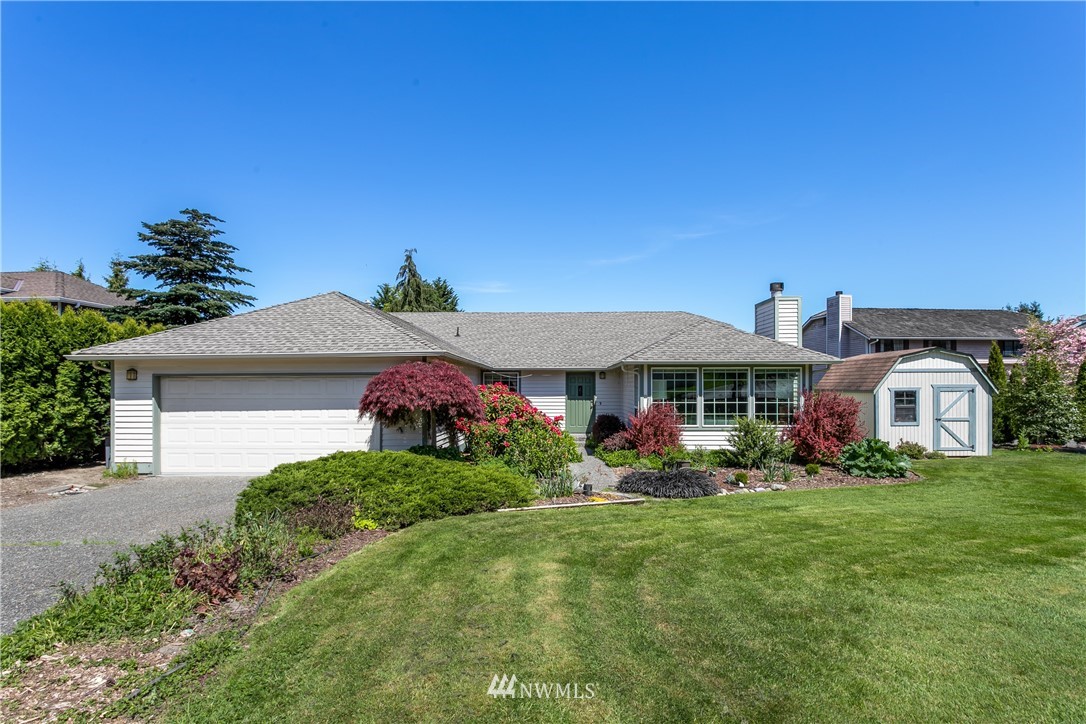 2003 237th Street Southeast Bothell, WA 98021 - Photo 1 of 25 a front view of a house with garden