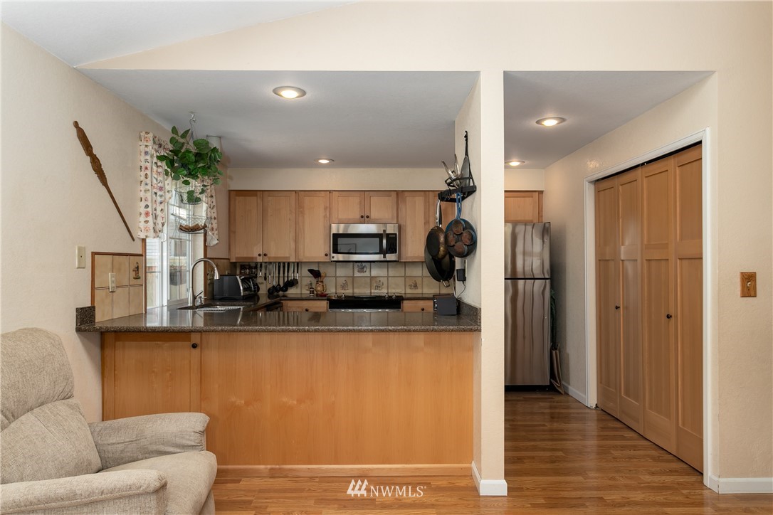 2003 237th Street Southeast Bothell, WA 98021 - Photo 11 of 25 a kitchen with stainless steel appliances granite countertop a refrigerator a stove and a sink