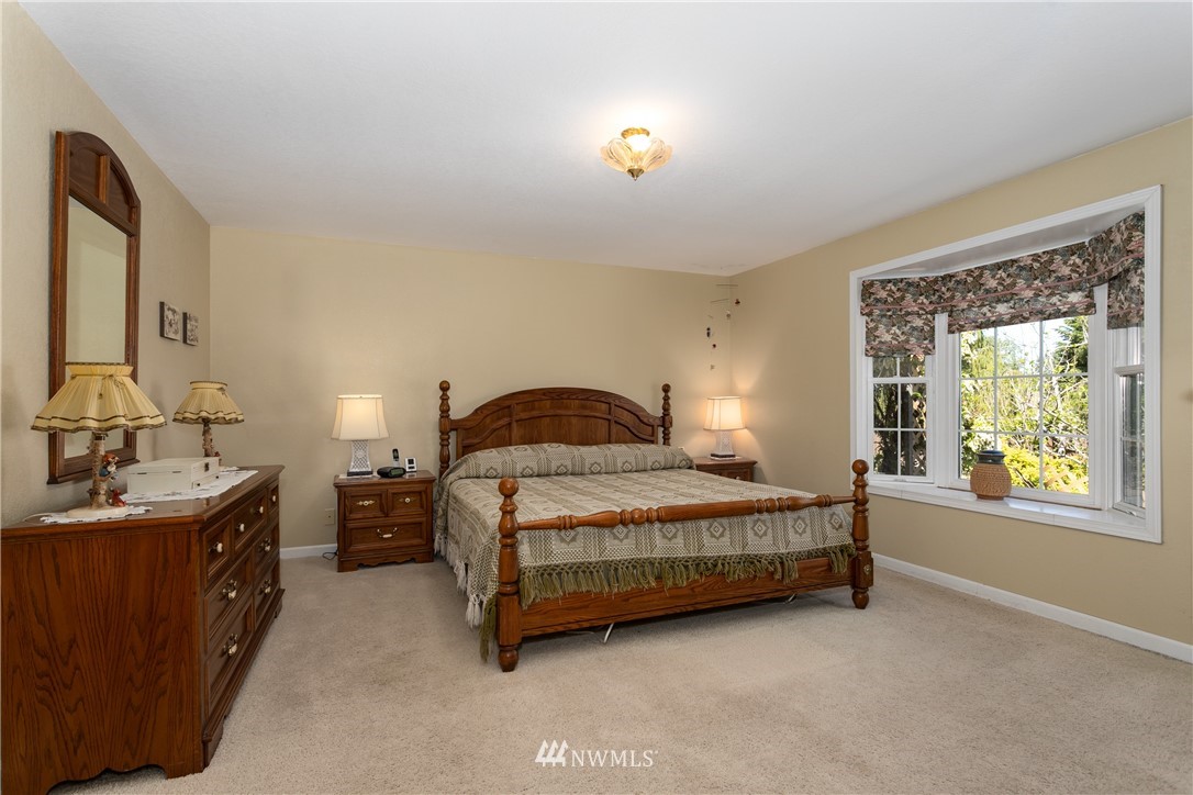 2003 237th Street Southeast Bothell, WA 98021 - Photo 14 of 25 a bedroom with a bed and a window