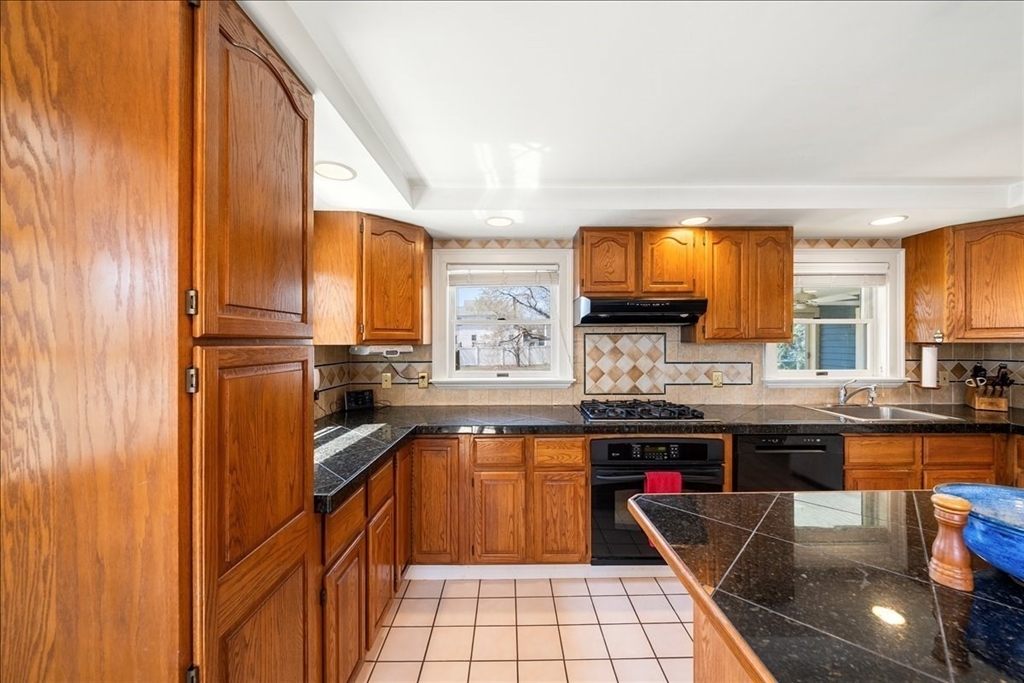 10 2nd Street Natick, MA 01760 - Photo 6 of 31 a kitchen with stainless steel appliances granite countertop sink stove and cabinets