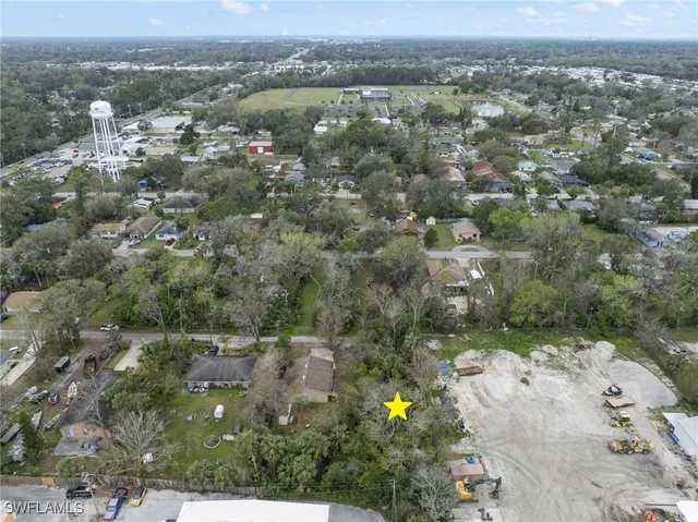 an aerial view of house with yard and mountain view in back