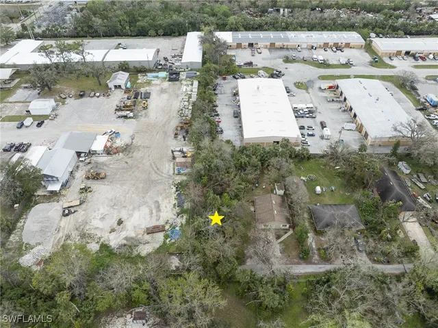 an aerial view of a house with a yard and lake view