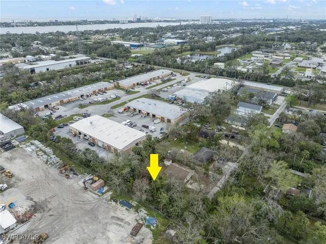 an aerial view of a house with a swimming pool yard and mountain view in back