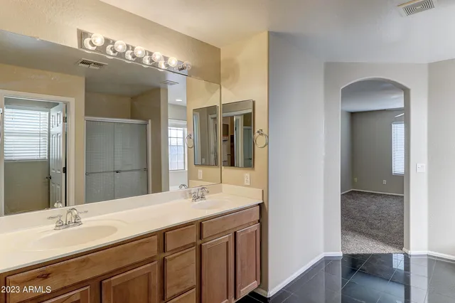 a bathroom with a double vanity sink and a mirror