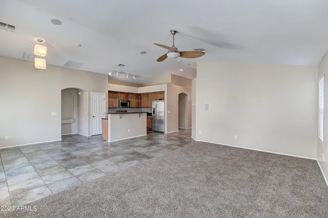 a view of a kitchen with a sink and a refrigerator