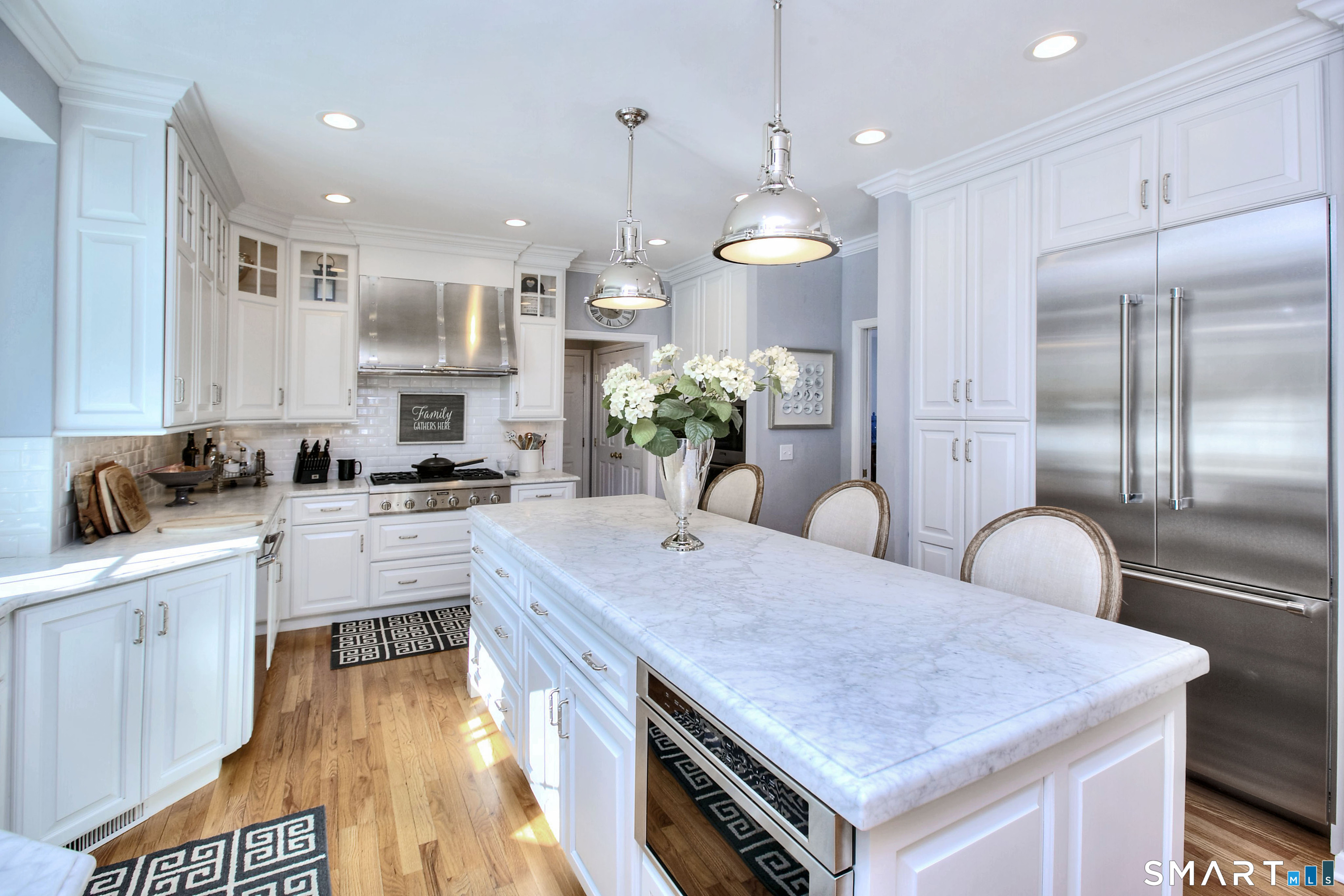 28 Great Pond Road Ridgefield, CT 06877 - Photo 11 of 40 a kitchen with stainless steel appliances granite countertop a kitchen island a stove a table and chairs