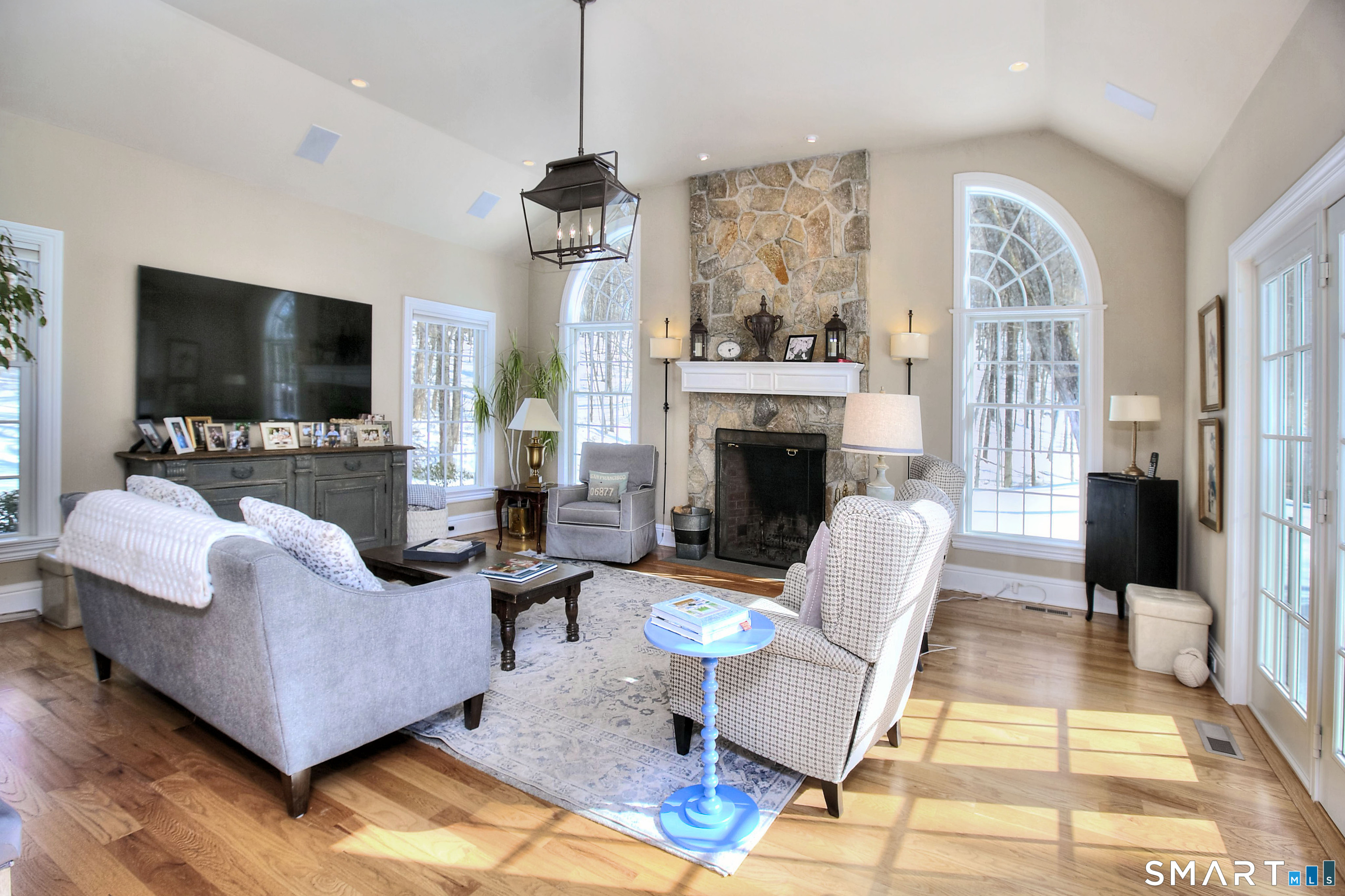 28 Great Pond Road Ridgefield, CT 06877 - Photo 17 of 40 a living room with furniture a flat screen tv and a fireplace