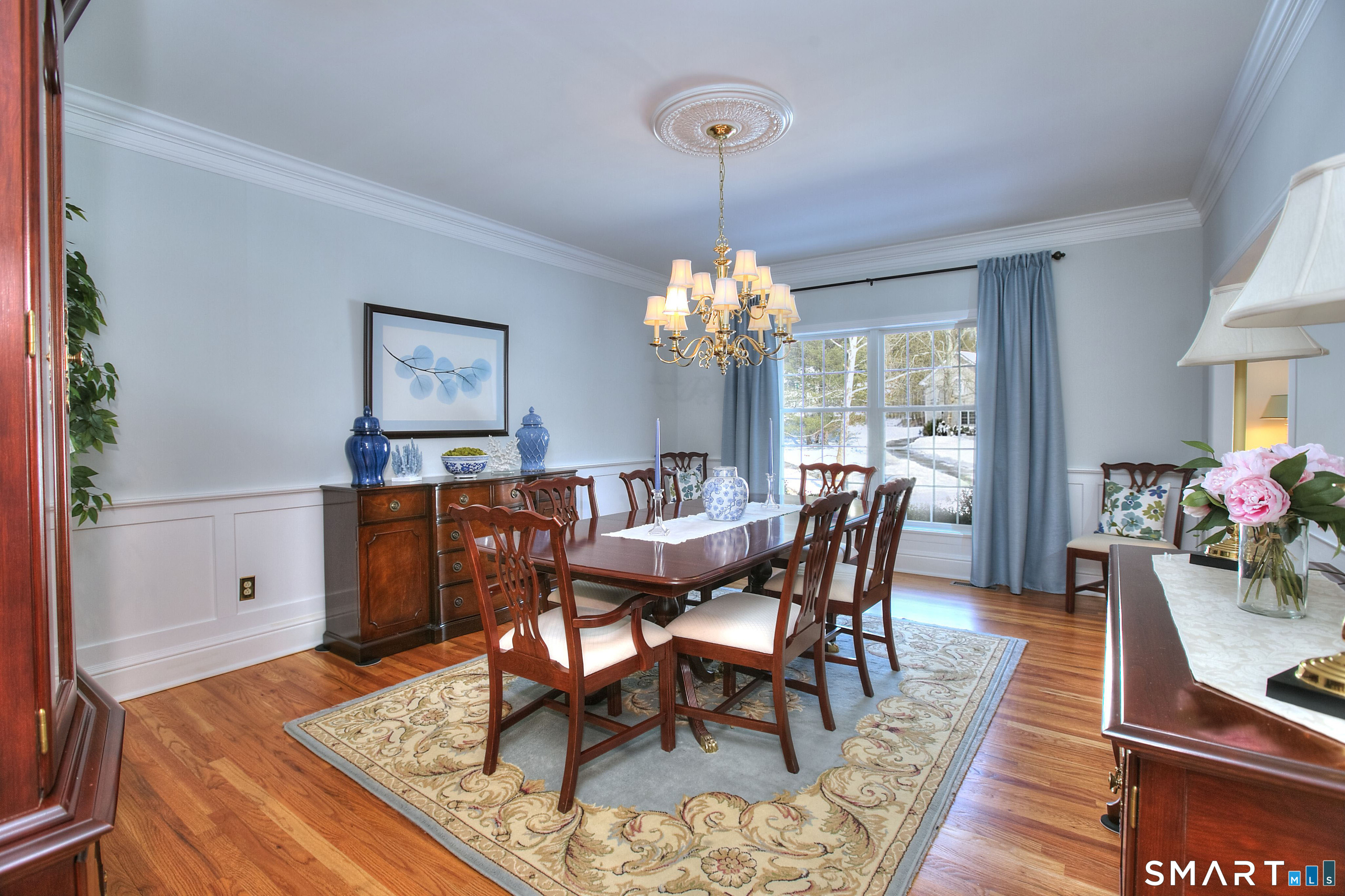 28 Great Pond Road Ridgefield, CT 06877 - Photo 20 of 40 a dining room with furniture a chandelier and wooden floor