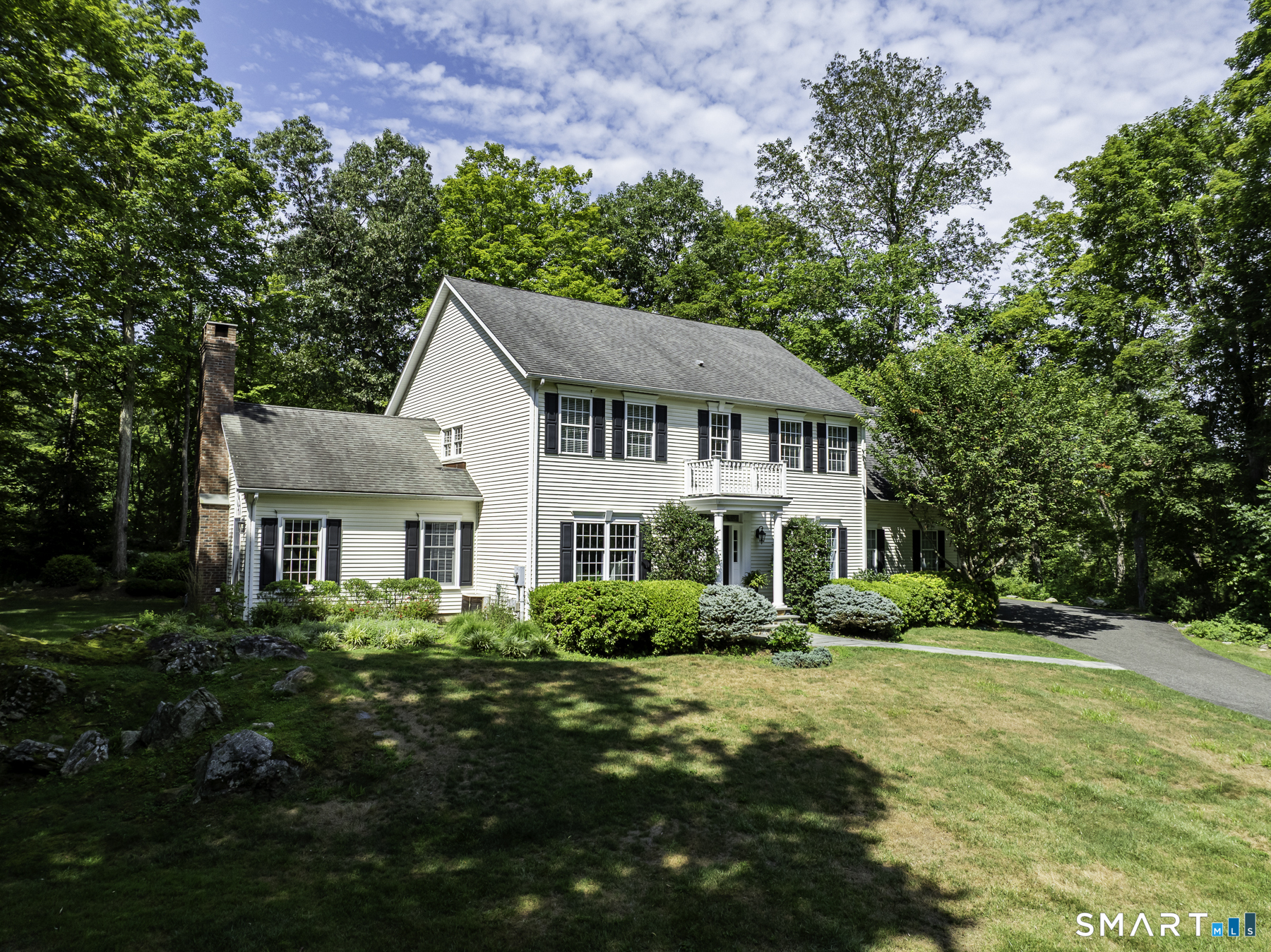 28 Great Pond Road Ridgefield, CT 06877 - Photo 2 of 40 a front view of a house with a garden