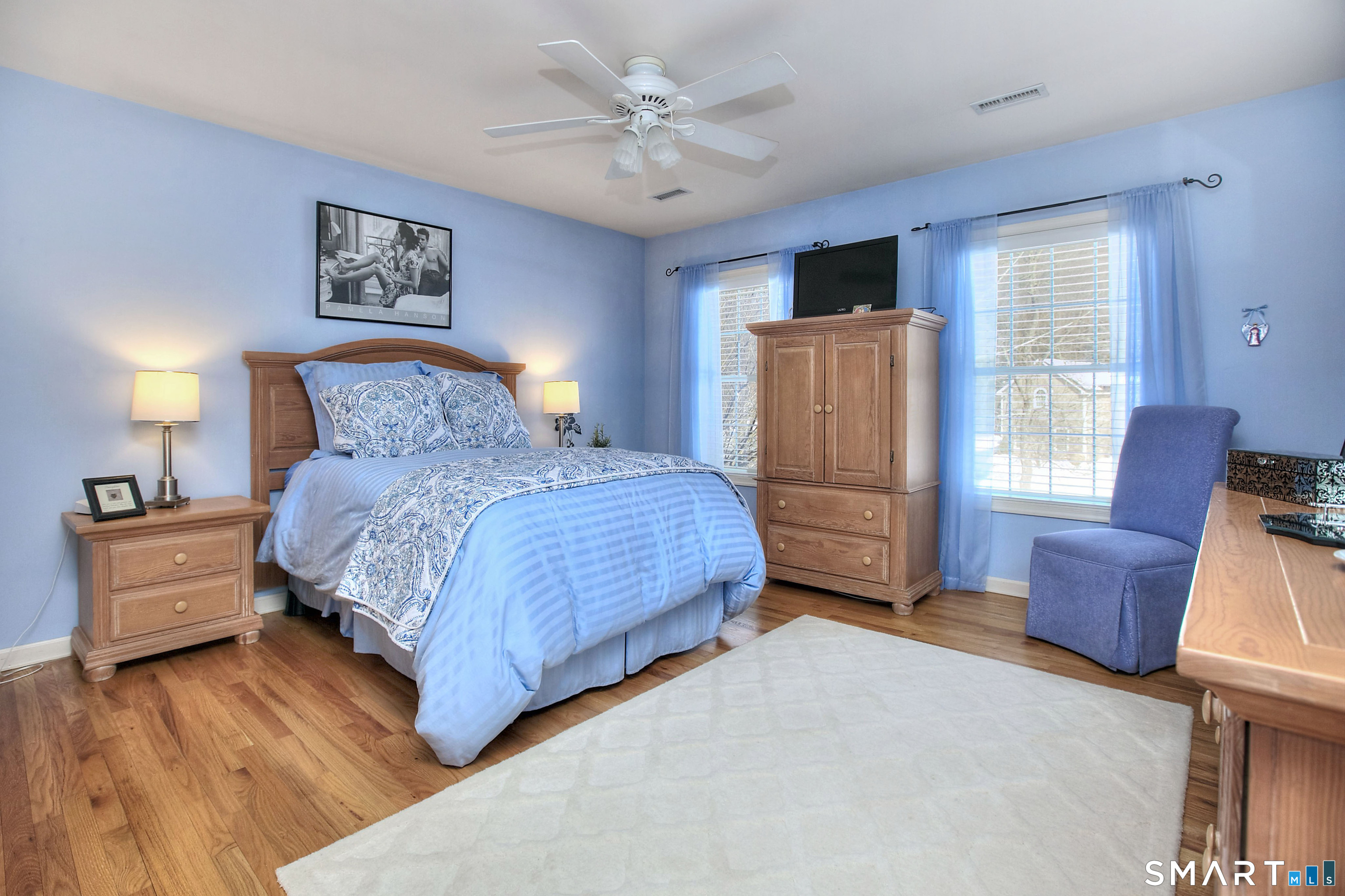 28 Great Pond Road Ridgefield, CT 06877 - Photo 36 of 40 a bedroom with a large bed and a chandelier