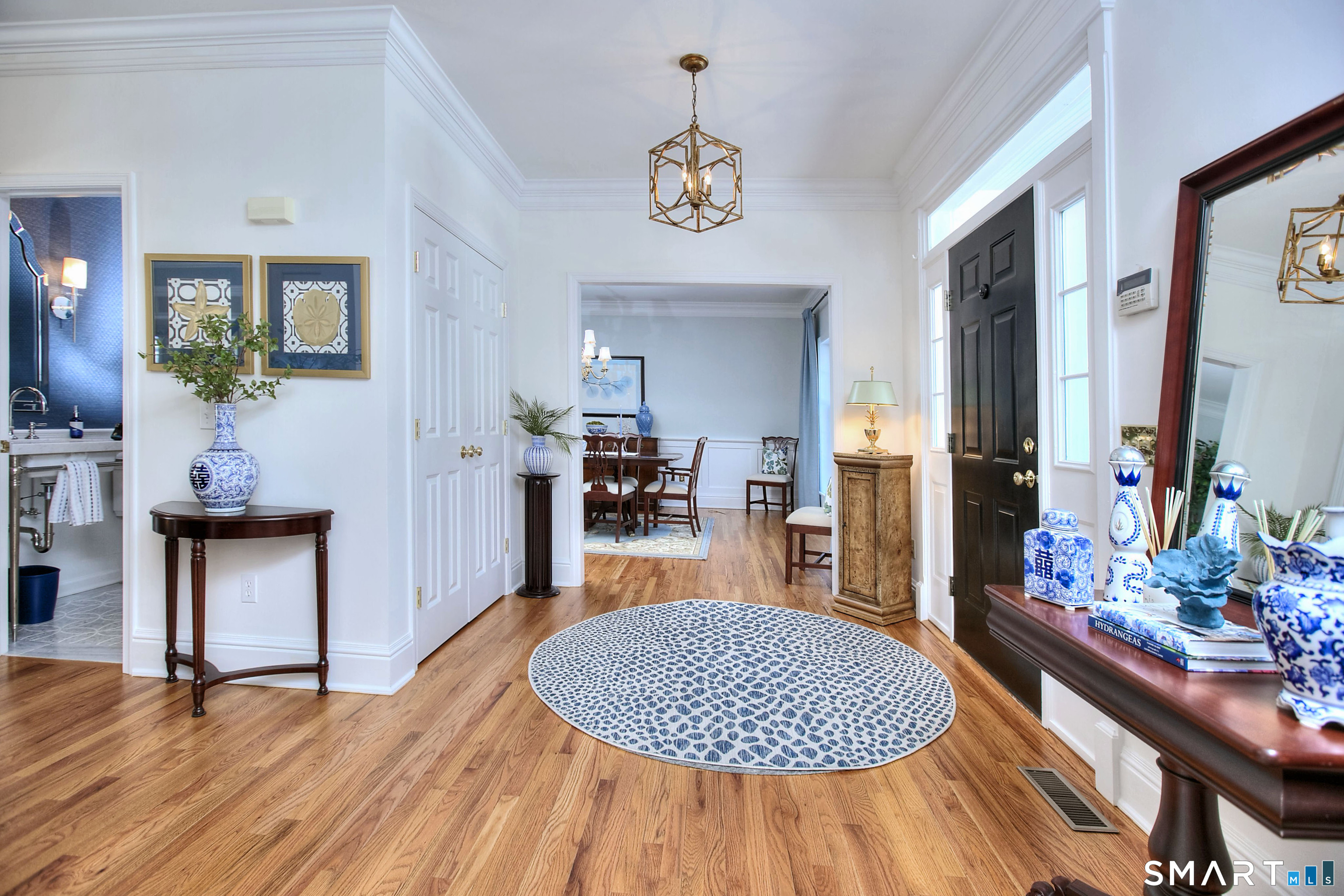 28 Great Pond Road Ridgefield, CT 06877 - Photo 4 of 40 a room with dining table and a wooden floor