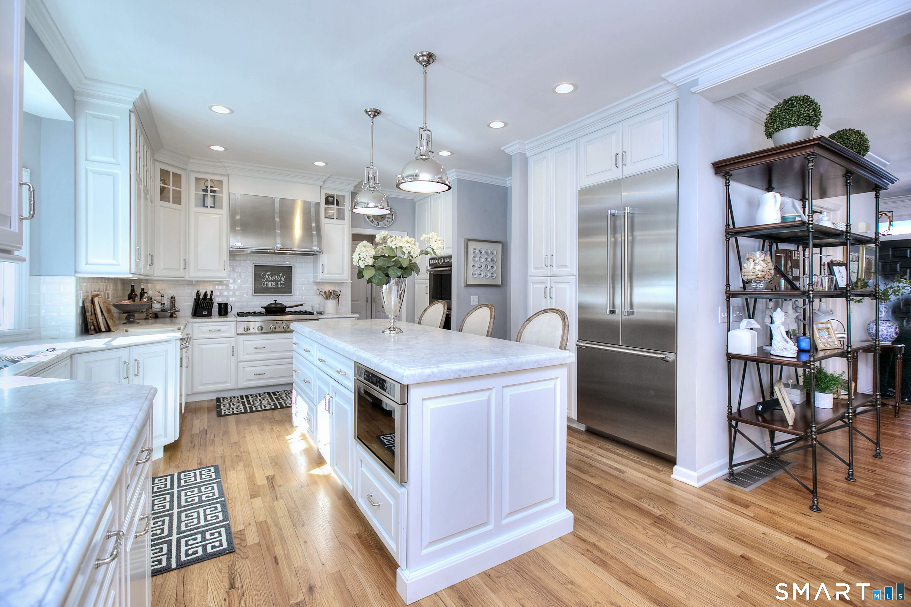 28 Great Pond Road Ridgefield, CT 06877 - Photo 6 of 40 a kitchen with stainless steel appliances granite countertop a refrigerator a stove and a wooden floors