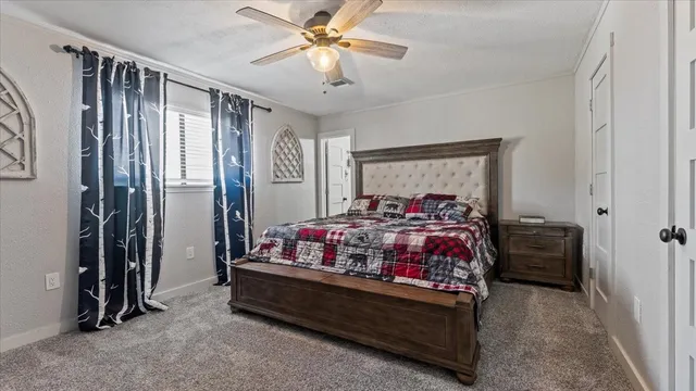 a bed sitting in a bedroom next to a window