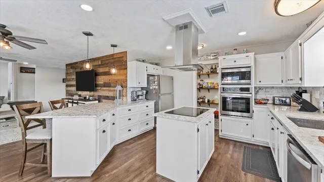 a kitchen that has a lot of cabinets and refrigerator
