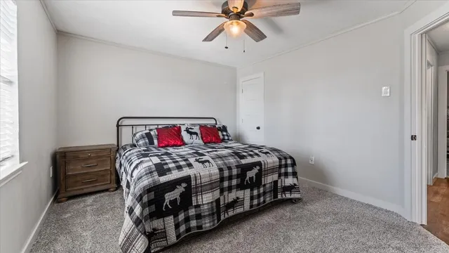 a bedroom with a bed and window