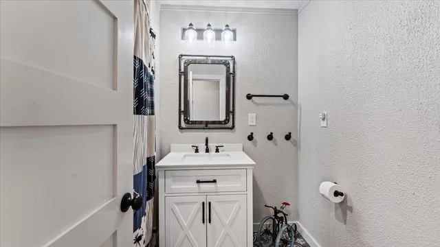 a bathroom with a sink vanity and a mirror