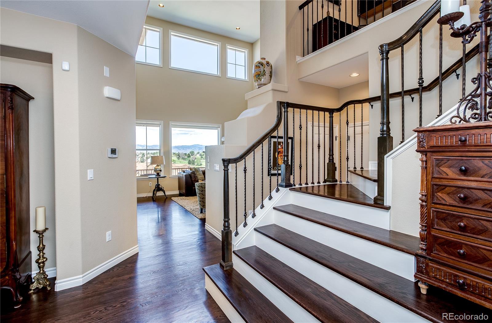 9349 Viaggio Way Highlands Ranch, CO 80126 - Photo 4 of 35 a view of staircase with lots of frames on wall and a window