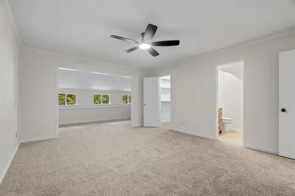 a view of an empty room with closet and window