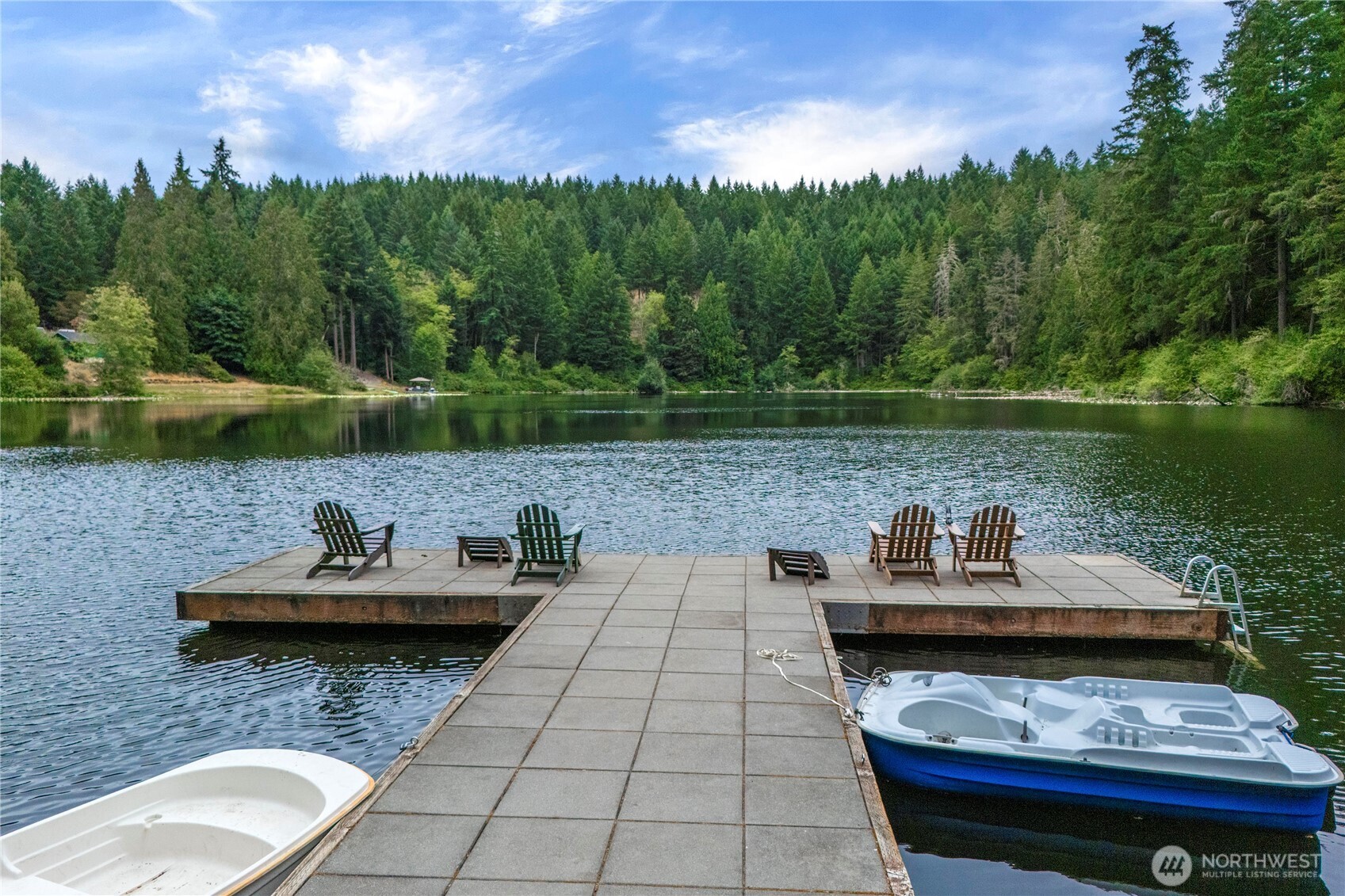 1546 Reservation Road Southeast, Unit 149 Olympia, WA 98513 - Photo 26 of 38 a view of a lake with couches and wooden floor
