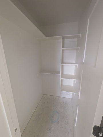 2771 West Aurora Avenue Mapleton, UT 84664 - Photo 27 of 39 White built-in shelving system with multiple shelves in a dedicated storage area