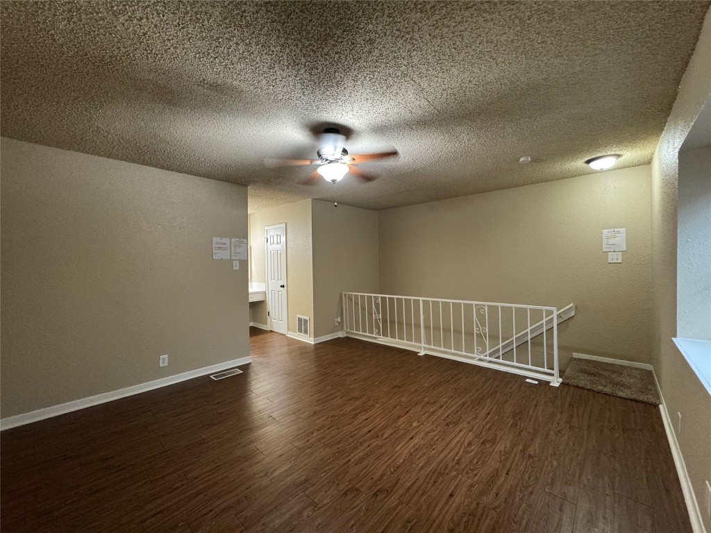 5006 West Wind Trail, Unit 104 Austin, TX 78745 - Photo 11 of 20 an empty room with wooden floor and windows