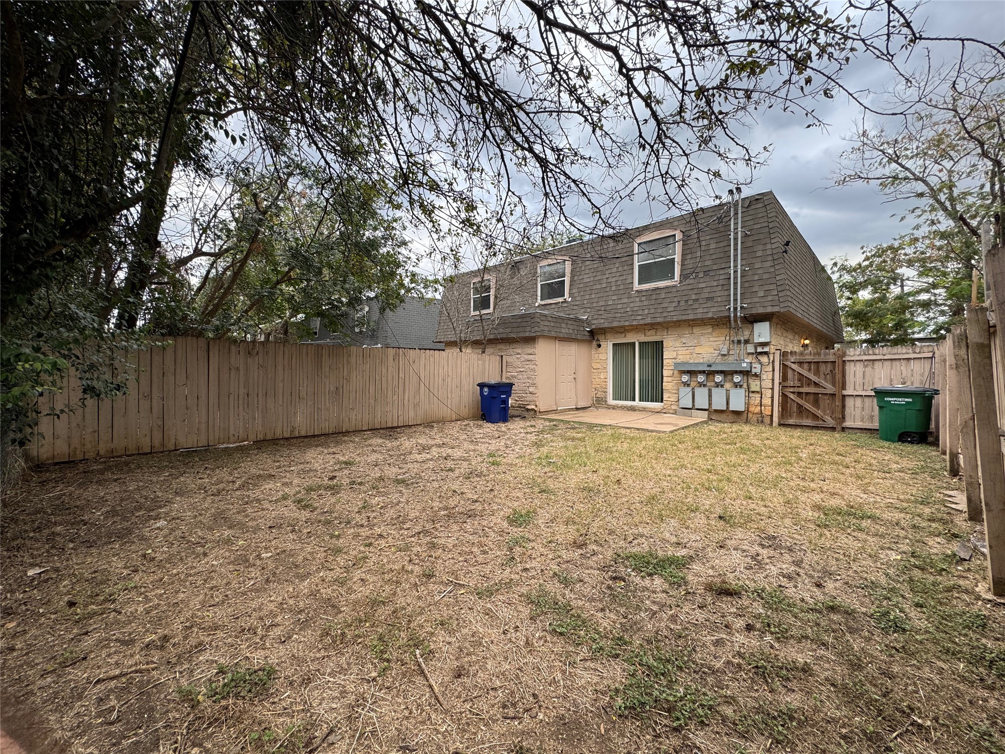 5006 West Wind Trail, Unit 104 Austin, TX 78745 - Photo 17 of 20 a front view of a house with a yard and garage